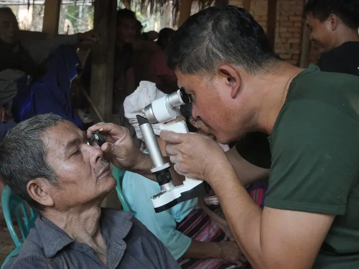 Dr. Nay Hser examining a patient during a community eye mission