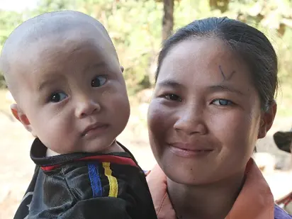 A Karen mother and child whose family has access to compassionate care